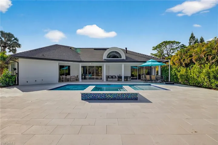 Combined pool / hot tub featuring outdoor lounge area and a patio area