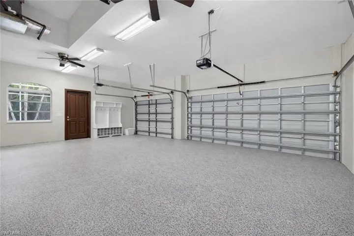 Garage with ceiling fan and a garage door opener
