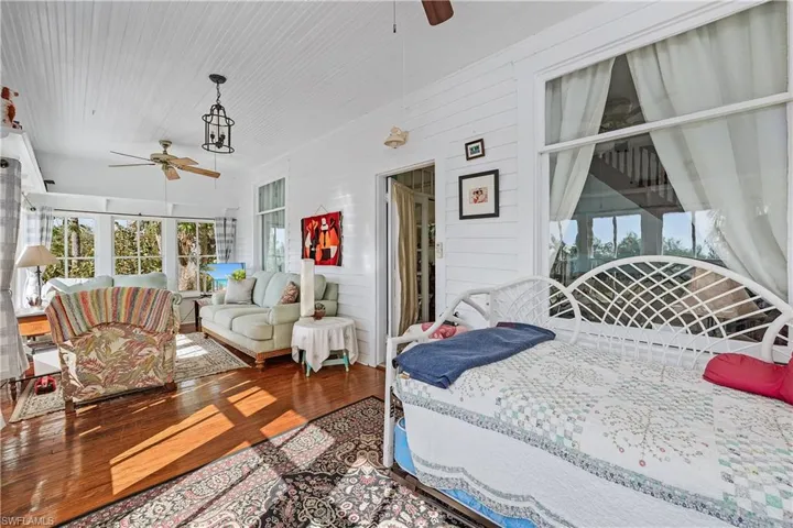 Bedroom featuring hardwood / wood-style flooring and wooden walls