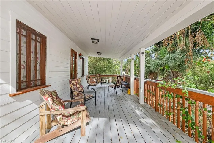 Wooden terrace featuring covered porch