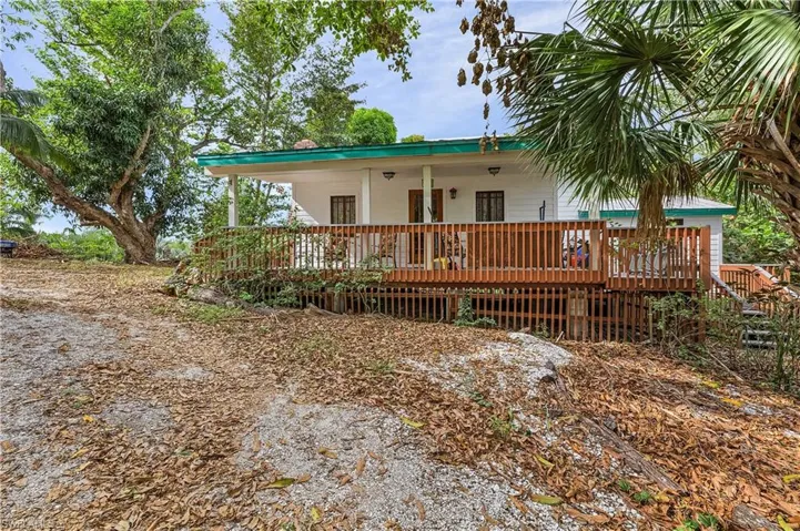 View of front of home with a wooden deck