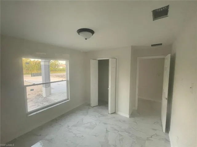 Unfurnished bedroom with light tile patterned floors