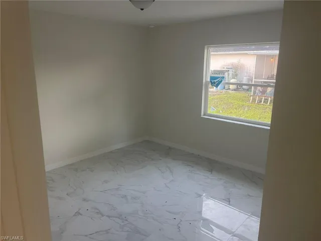 Unfurnished room with light tile patterned flooring