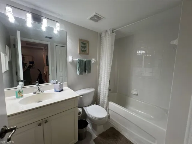 Full bath featuring vanity and shower / tub combo with curtain