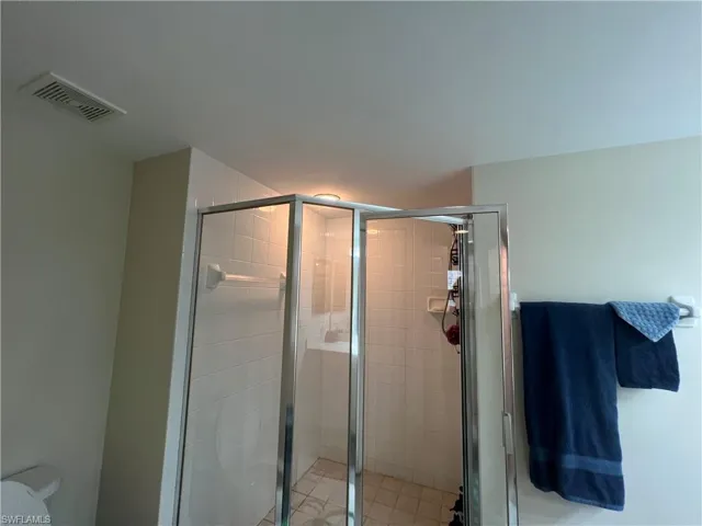 Bathroom featuring toilet and a shower stall