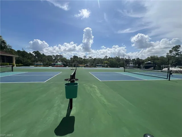 View of tennis court featuring community basketball court