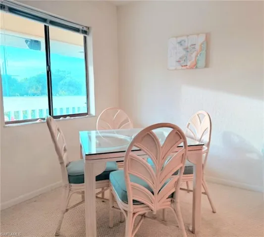 Carpeted dining room featuring baseboards