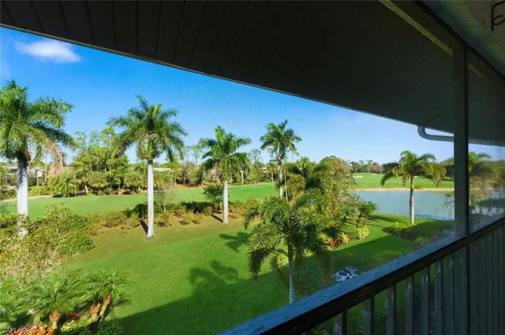Balcony featuring a water view, golf course view, and a sunroom