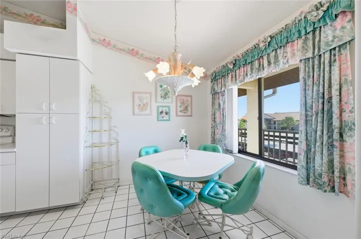 Dining area featuring hanging lights and light tile patterned floors
