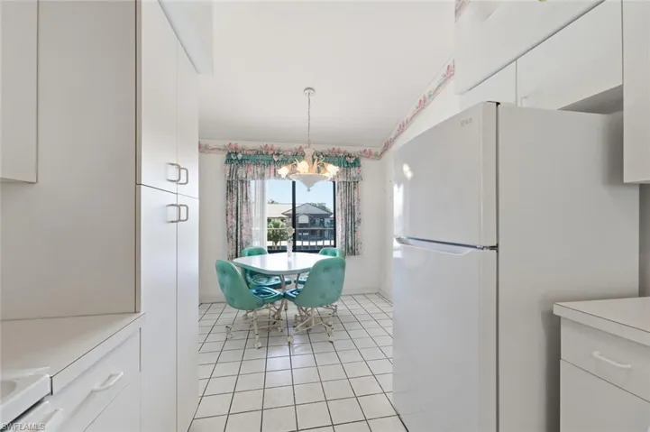 Dining room featuring light tile patterned floors and a chandelier