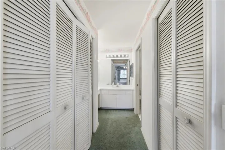 Hallway with dark colored carpet