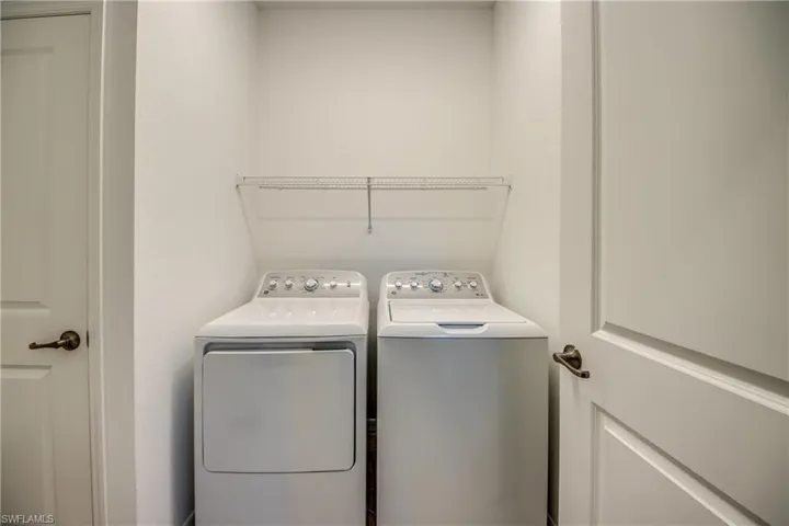 Washroom featuring washing machine and clothes dryer