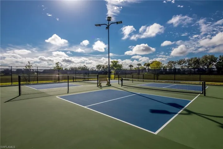 View of tennis court with community basketball court