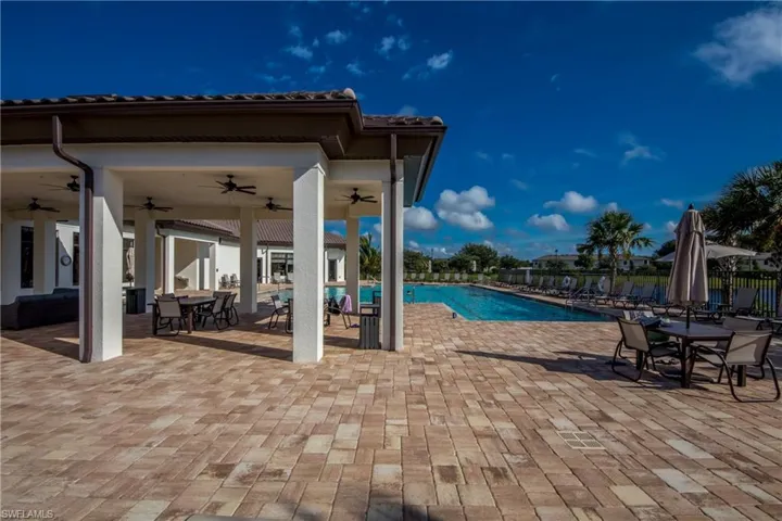 Community pool featuring a patio, a ceiling fan, and outdoor dining area