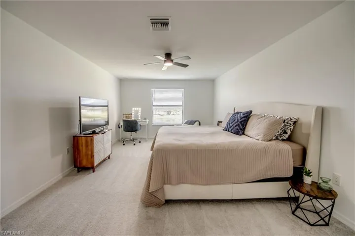 Bedroom with carpet flooring and a ceiling fan
