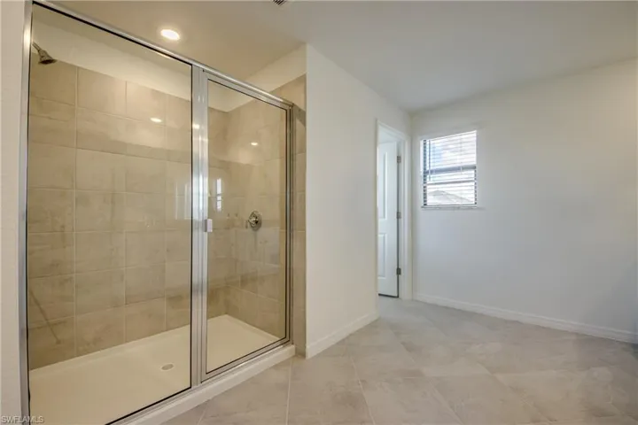 Bathroom featuring a stall shower and tile patterned floors