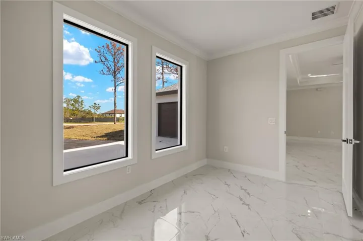 Spare room featuring ornamental molding