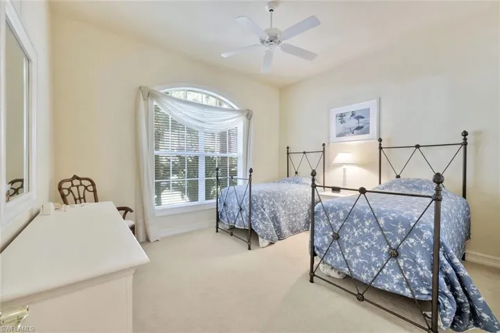 Bedroom featuring ceiling fan and light carpet