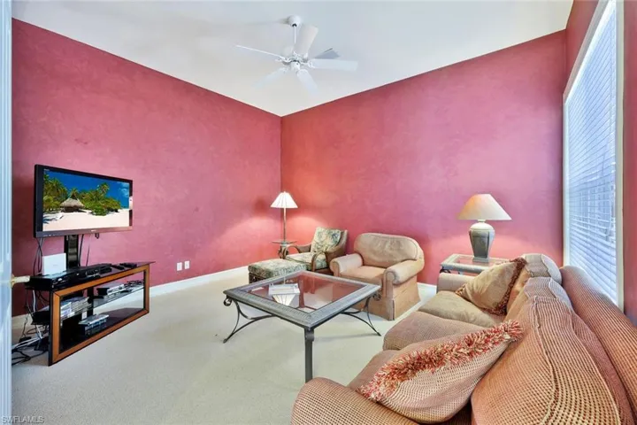 Carpeted Den /Office featuring ceiling fan with sleeper sofa