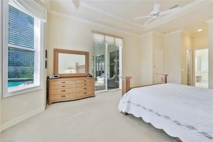 Carpeted bedroom with ceiling fan, ornamental molding, access to outside, and connected bathroom
