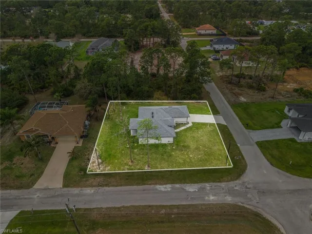 Aerial view of residential area with property parcel outlined