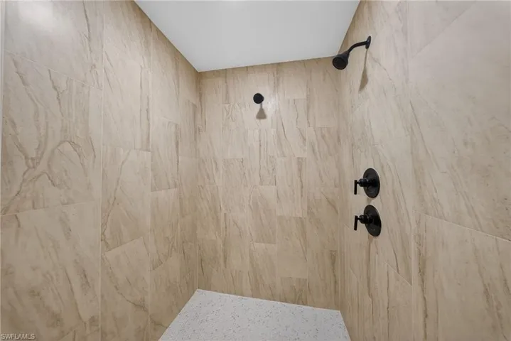 Full bathroom featuring tiled shower