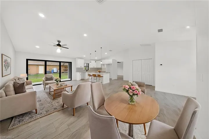 Dining area featuring vaulted ceiling, recessed lighting, light wood finished floors, and ceiling fan