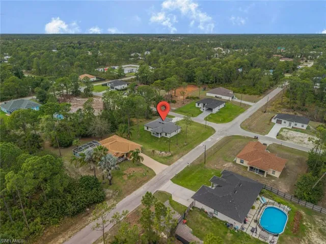 Aerial view of residential area with a heavily wooded area