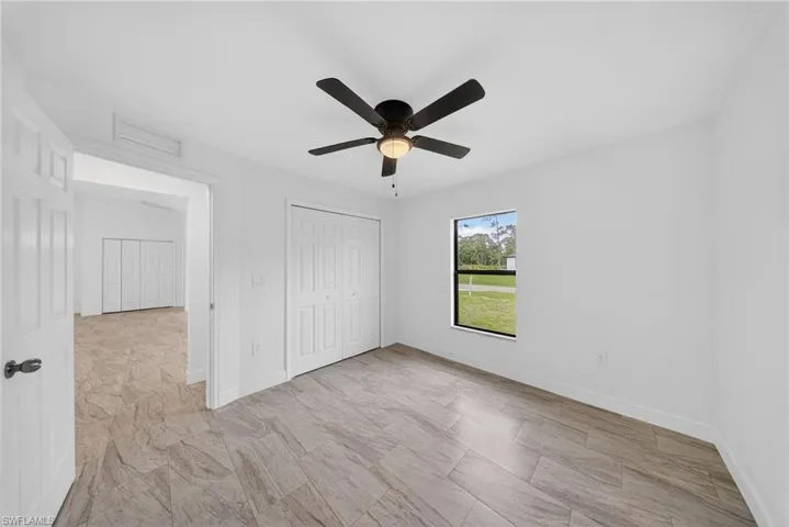 Unfurnished bedroom featuring a ceiling fan and a closet