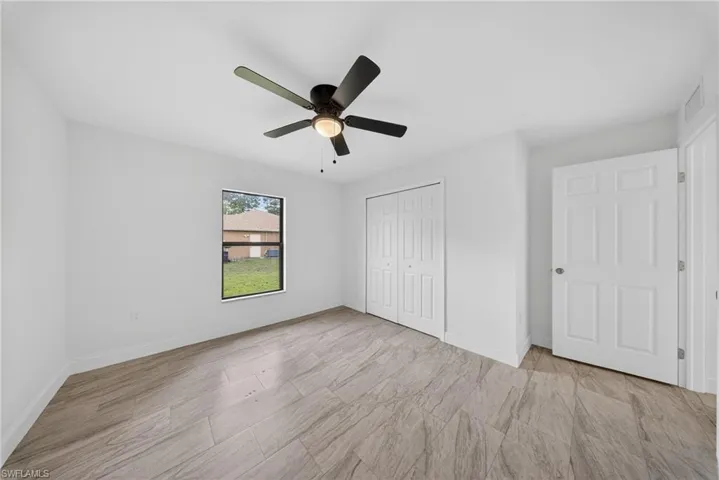 Unfurnished bedroom featuring ceiling fan and a closet