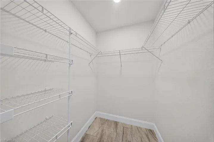 Walk in closet featuring light wood-style flooring