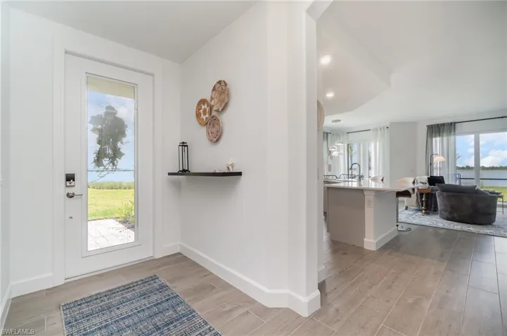 Foyer entrance featuring light wood-style flooring and baseboards