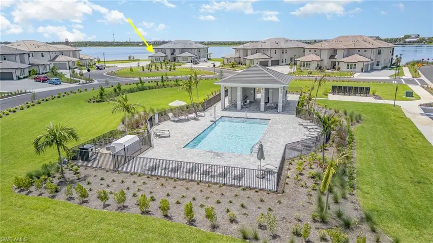 Community pool featuring a water view, a residential view, and a gazebo