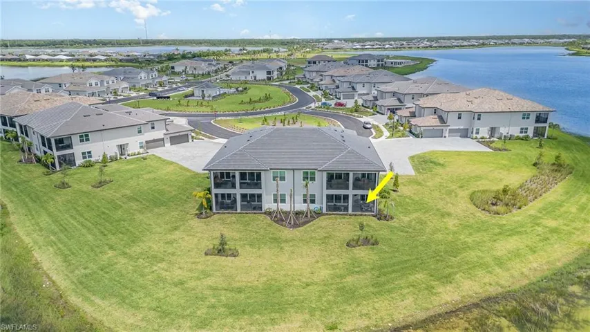 Aerial view of residential area featuring a nearby body of water