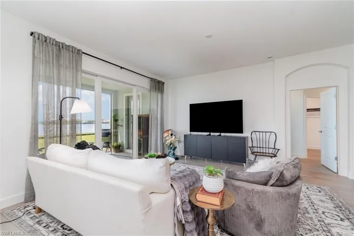 Living room with light wood finished floors and baseboards
