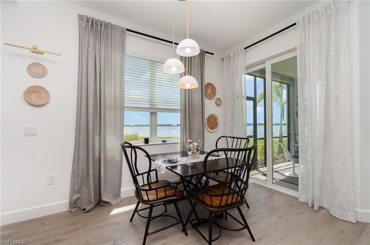 Dining space with plenty of natural light, a water view, and wood finished floors
