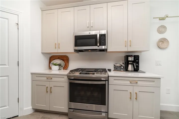 Kitchen featuring appliances with stainless steel finishes and light countertops