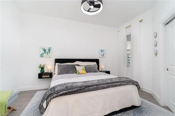 Bedroom featuring wood finished floors and baseboards