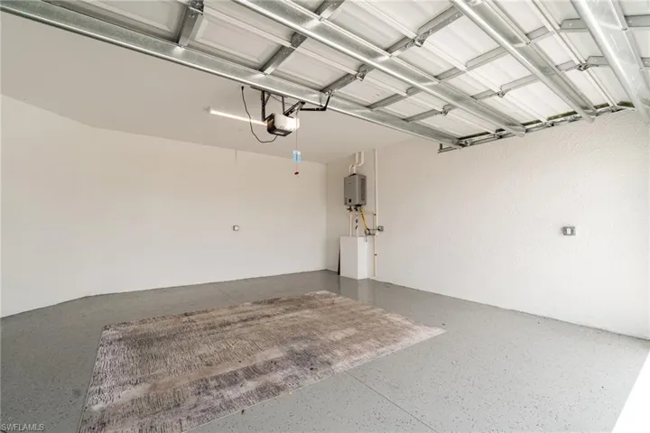 Garage with water heater and a garage door opener