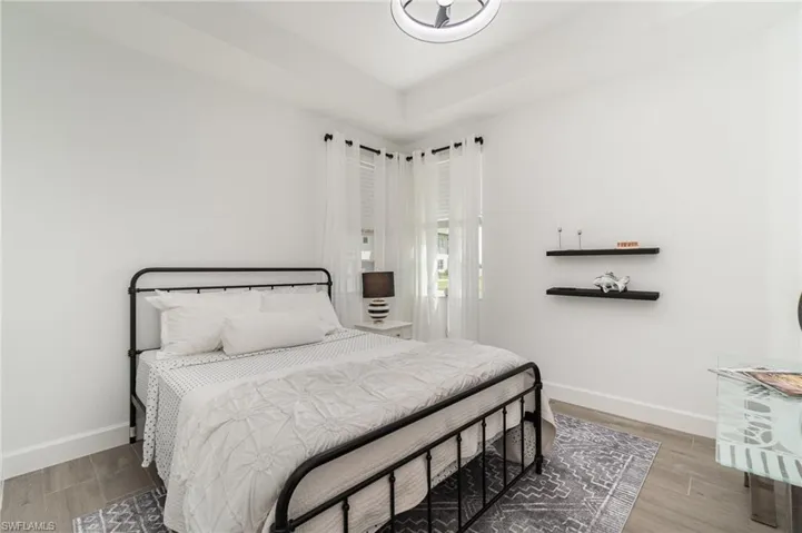 Bedroom with baseboards and wood finished floors