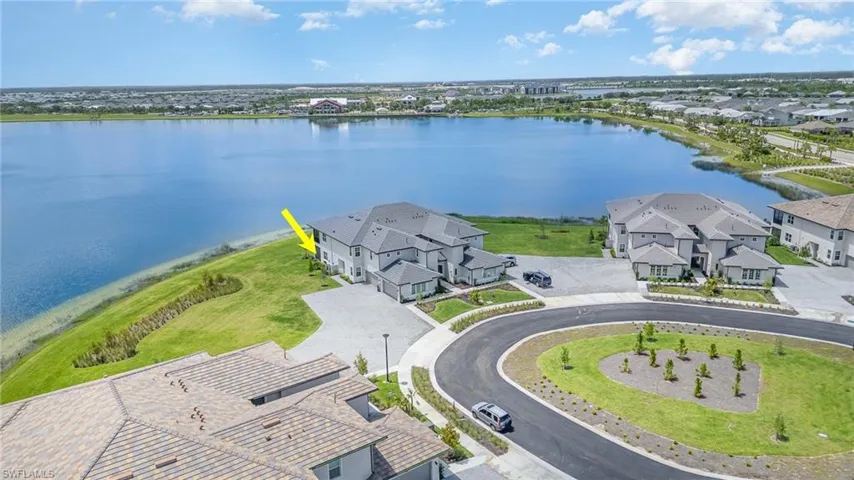Aerial view of residential area featuring a nearby body of water