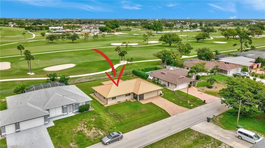 Aerial perspective of suburban area featuring a golf course