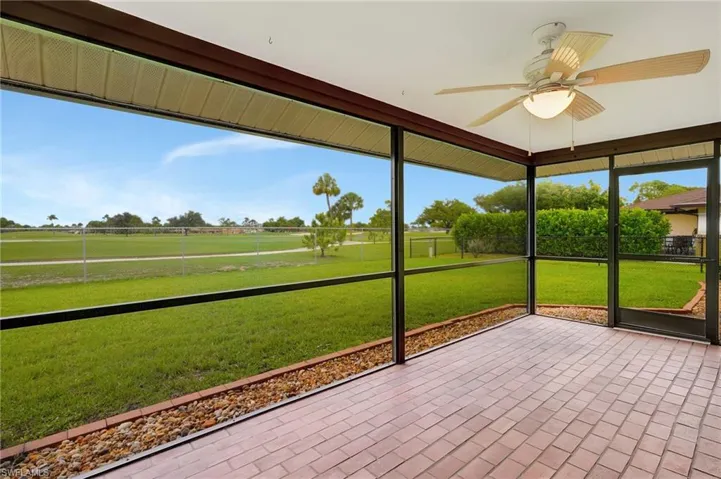 Unfurnished sunroom featuring ceiling fan