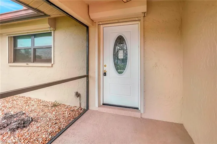 View of exterior entry with stucco siding