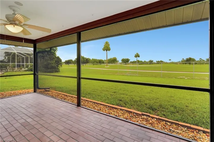 Unfurnished sunroom featuring a ceiling fan and healthy amount of natural light