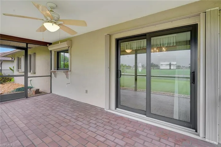 Unfurnished sunroom with a ceiling fan and healthy amount of natural light