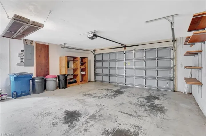 Garage with electric panel and a garage door opener