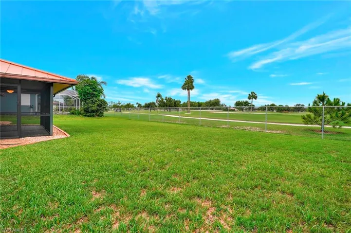 View of yard with a sunroom and a view of countryside