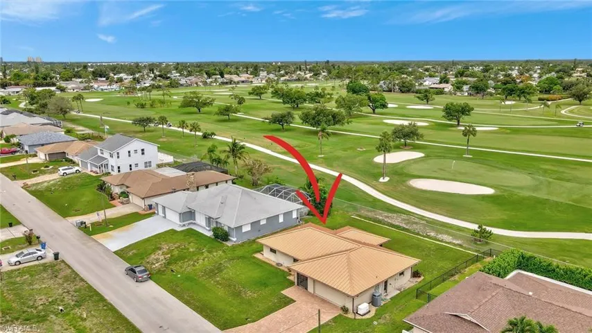 Aerial view of residential area featuring a golf club