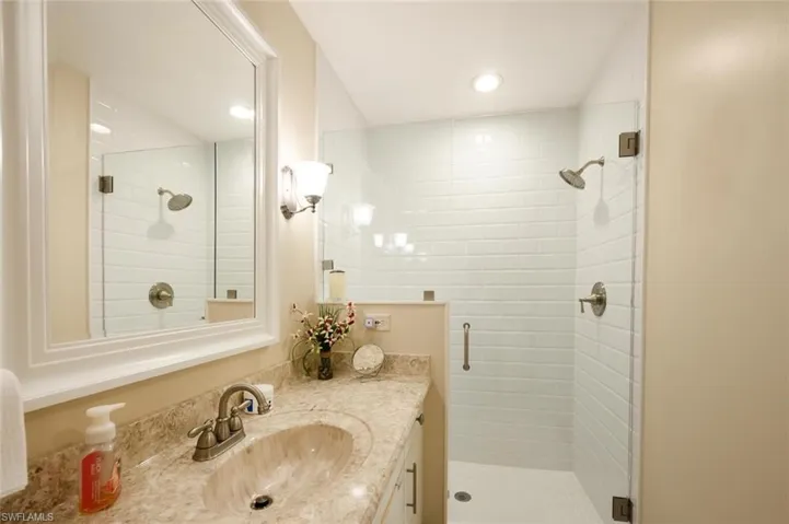 Full bathroom featuring vanity and a stall shower